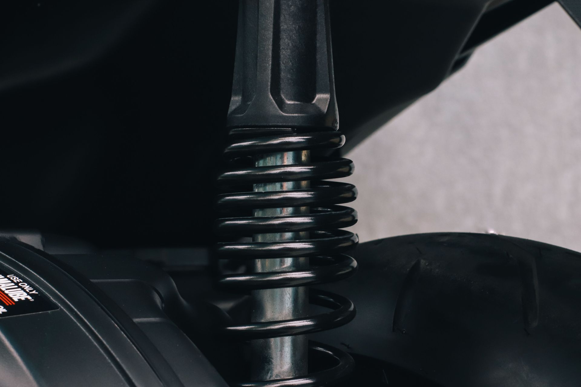 Detailed view of a motorcycle's suspension spring and metal components